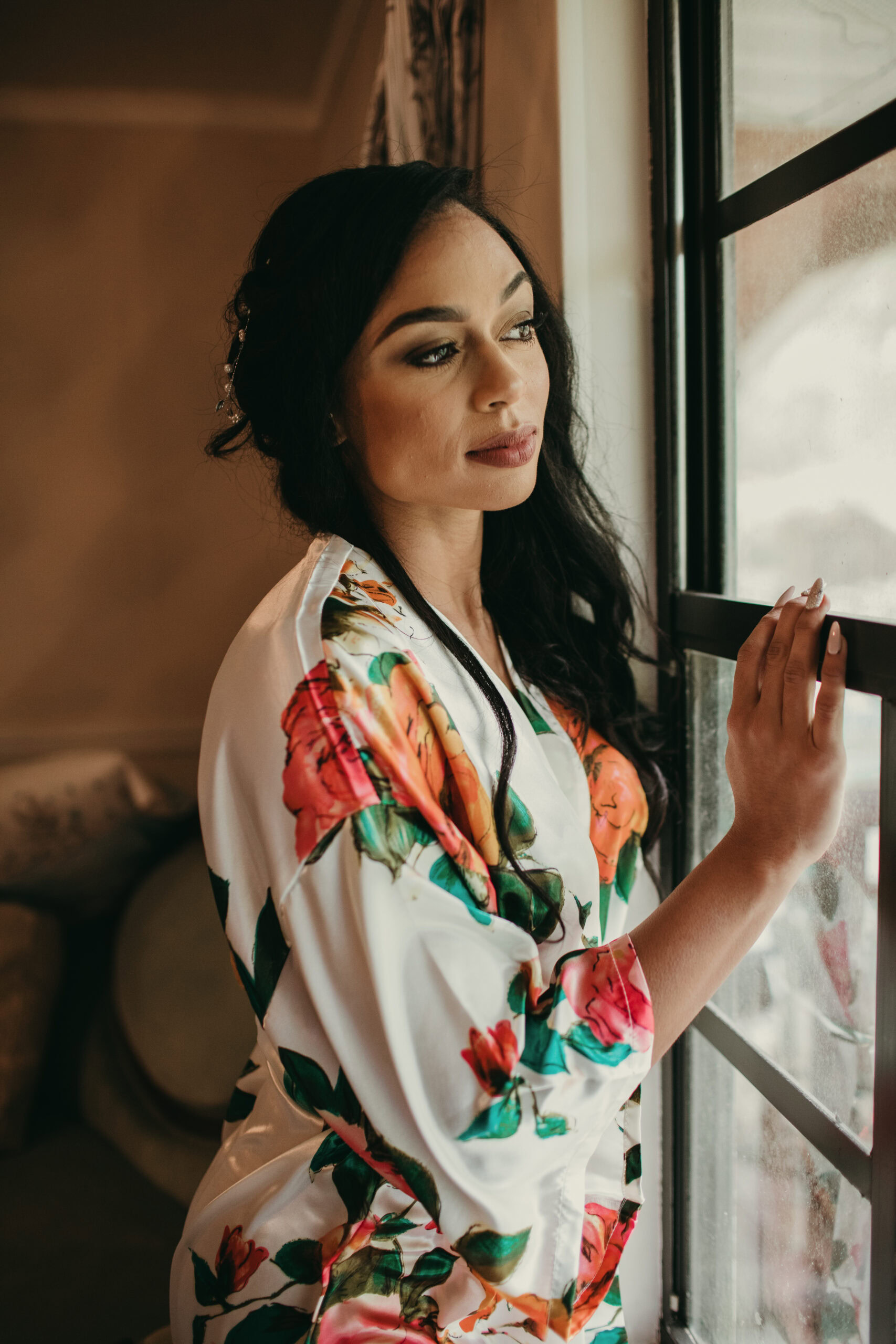 Woman gazing thoughtfully through a window, showcasing natural beauty and contemplative mood.
