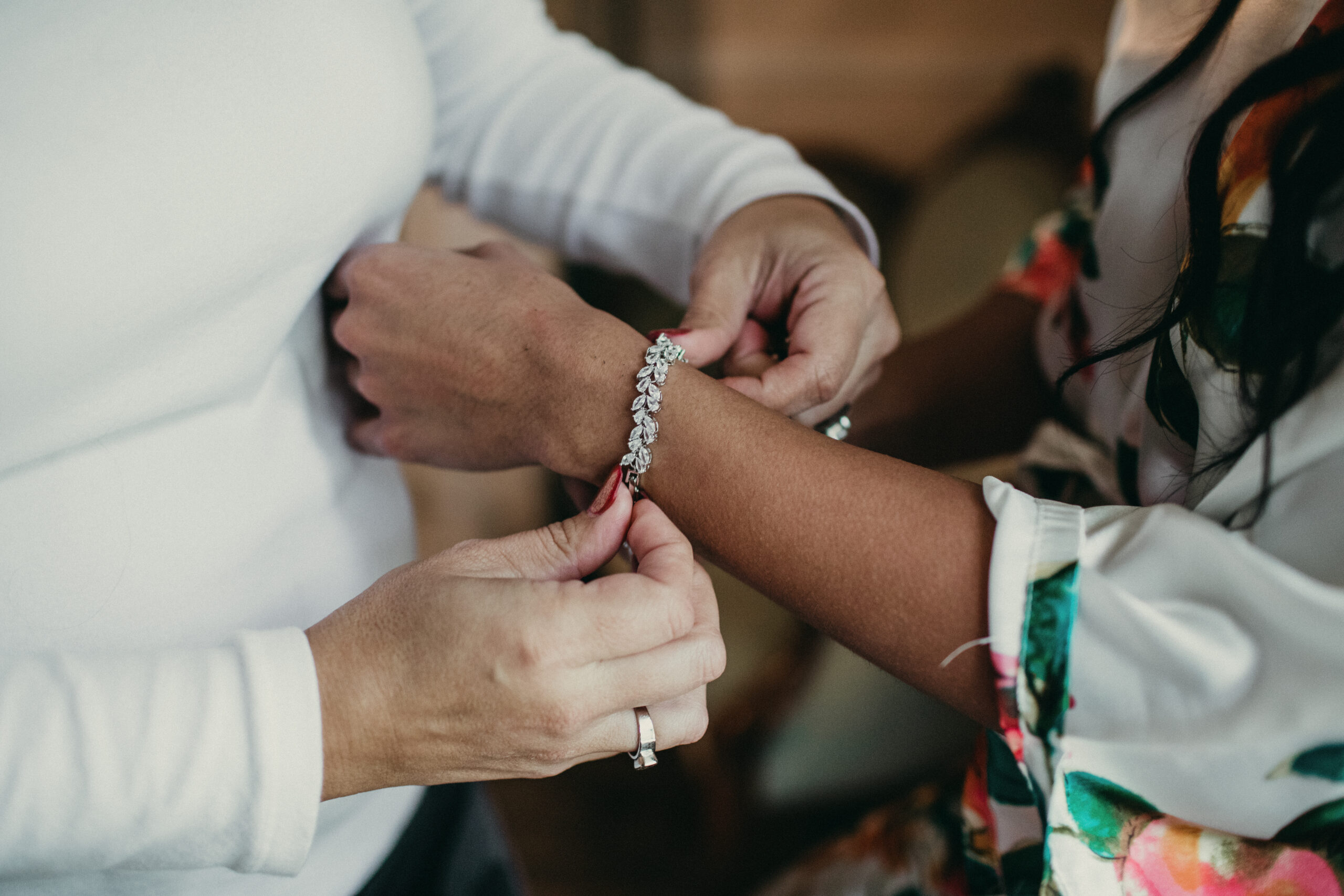 Bride and groom exchanging jewelry during wedding ceremony.
